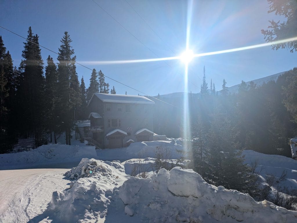 Breckenridge Tree Removal Bright sun in the background heavy snow